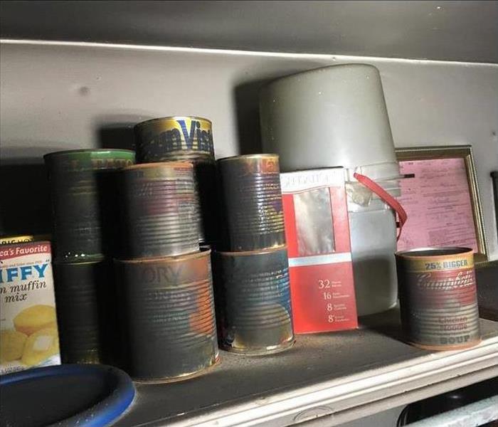 Photo of soot covered cans 