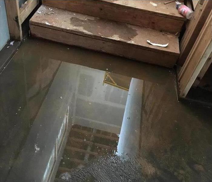Photo of flooded flooring with wooden stairs